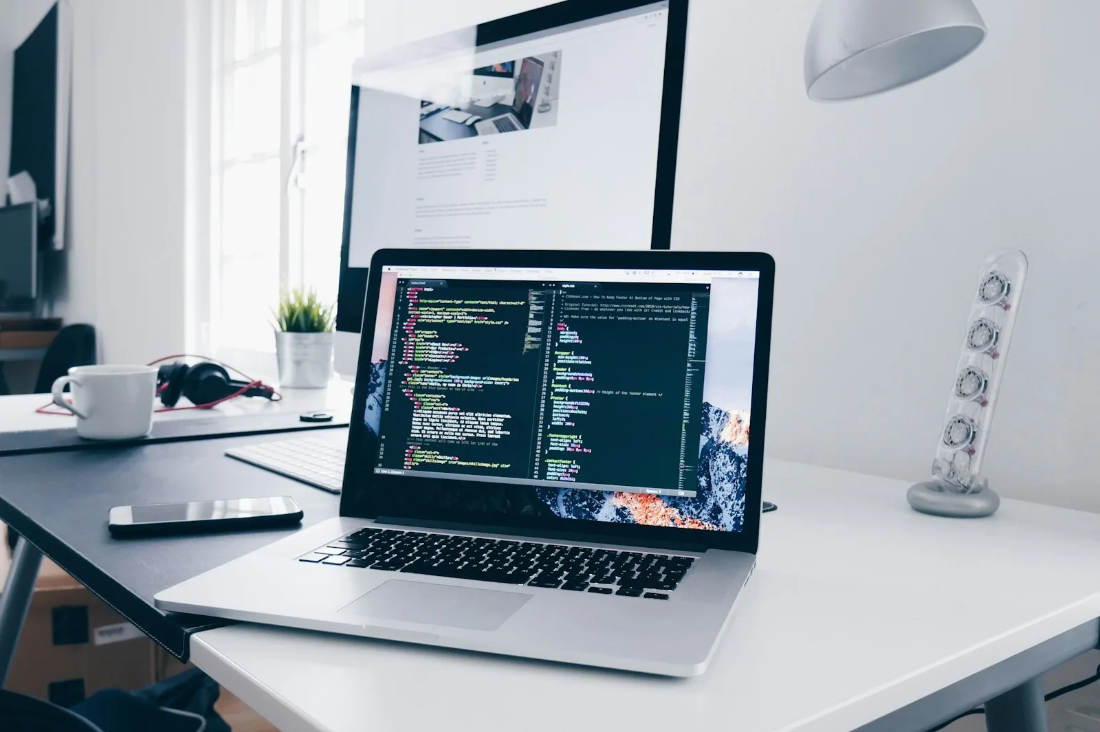 Laptop with code on screen on a clean desk